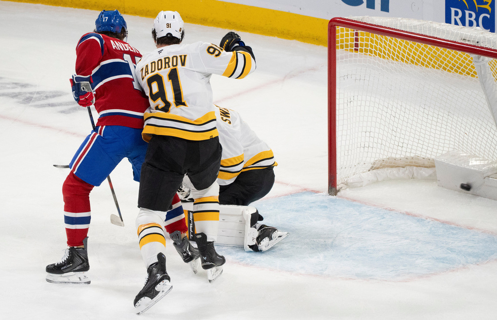 Montreal Canadiens' Josh Anderson (17) scores on Boston Bruins goaltender Jeremy Swayman (1) as Bruins' Nikita Zadorov (91) defends during the second period of an NHL hockey game in Montreal, Tuesday, March 17, 2026. (Christinne Muschi/The Canadian Press via AP)