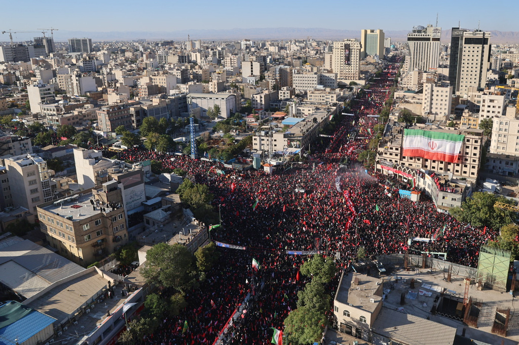 Thousands of mourners fill a square and adjoining avenues, stretching for blocks, during the final stage of funeral ceremonies for the late Iranian Supreme Leader Ayatollah Ali Khamenei and members of his family in Mashhad, northeastern Iran, Thursday, July 9, 2026. (Mohammad Hasan Salavati/Shahraranews via AP)