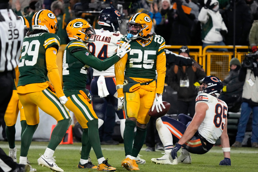 Green Bay Packers cornerback Keisean Nixon (25) celebrates after an interception against Chicago Bears tight end Cole Kmet (85) during the second half of an NFL football game Sunday, Dec. 7, 2025, in Green Bay, Wis. (AP Photo/Morry Gash)