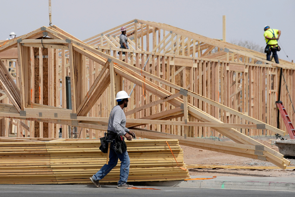 FILE - Construction workers install a lumber roof at a new home build Tuesday, April 1, 2025, in Laveen, Ariz. (AP Photo/Ross D. Franklin, File)
