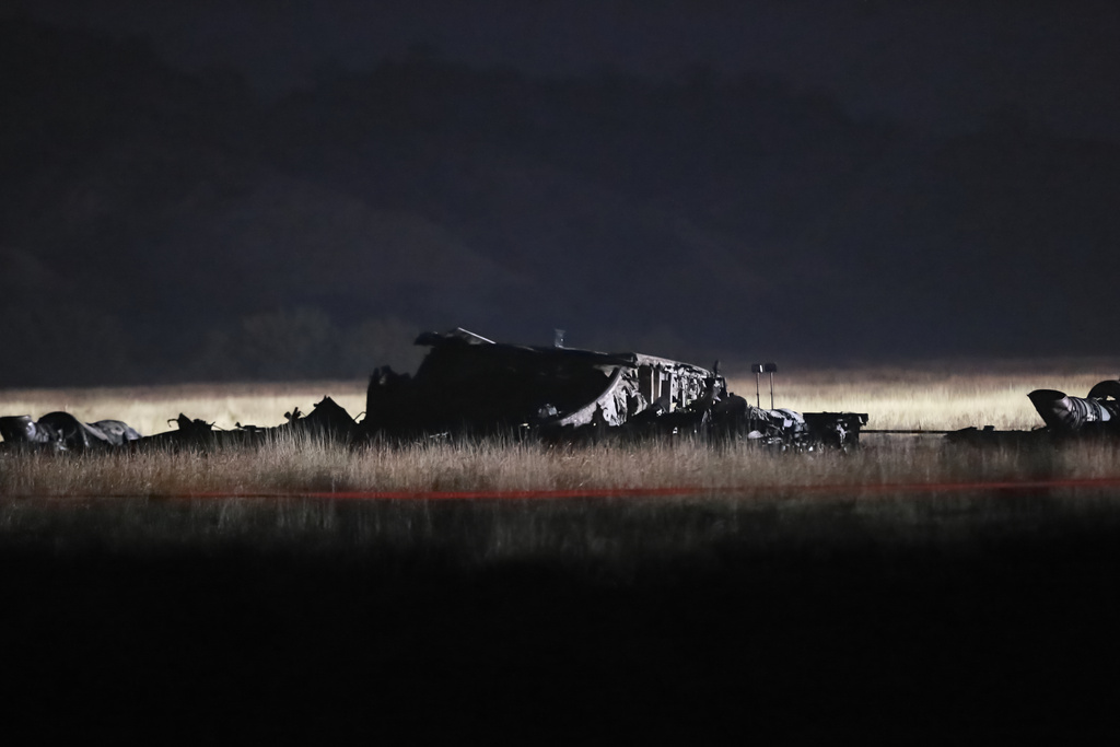 Debris is seen at a crash site of a Turkish military cargo plane in Georgia's Sighnaghi municipality, close to the Azerbaijani border on Wednesday, Nov. 12, 2025. (AP Photo/Zurab Tsertsvadze)