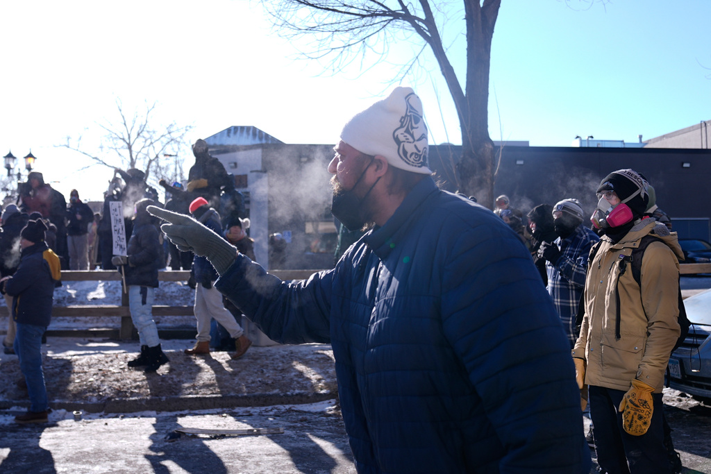 A person yells at federal immigration officers, Saturday, Jan. 24, 2026, in Minneapolis. (AP Photo/Abbie Parr)