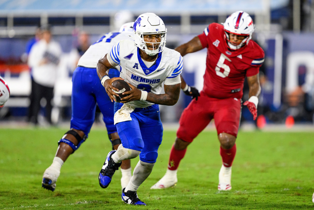 FILE - Memphis quarterback Brendon Lewis runs with the ball during an NCAA football game against Florida Atlantic, Sept. 27, 2025 in Boca Raton, Fla. (AP Photo/Doug Murray, File)