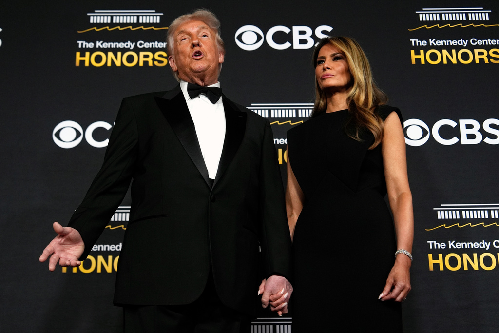 President Donald Trump and first lady Melania Trump, walk the red carpet before the 48th Kennedy Center Honors, Sunday, Dec. 7, 2025, at the John F. Kennedy Center for the Performing Arts in Washington. (AP Photo/Julia Demaree Nikhinson)