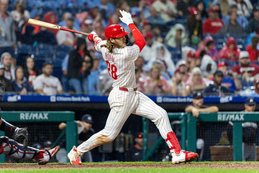 Philadelphia Phillies' Alec Bohm follows through on a single in the seventh inning of a baseball game against the Minnesota Twins, Saturday, Sept. 27, 2025, in Philadelphia. (AP Photo/Laurence Kesterson)