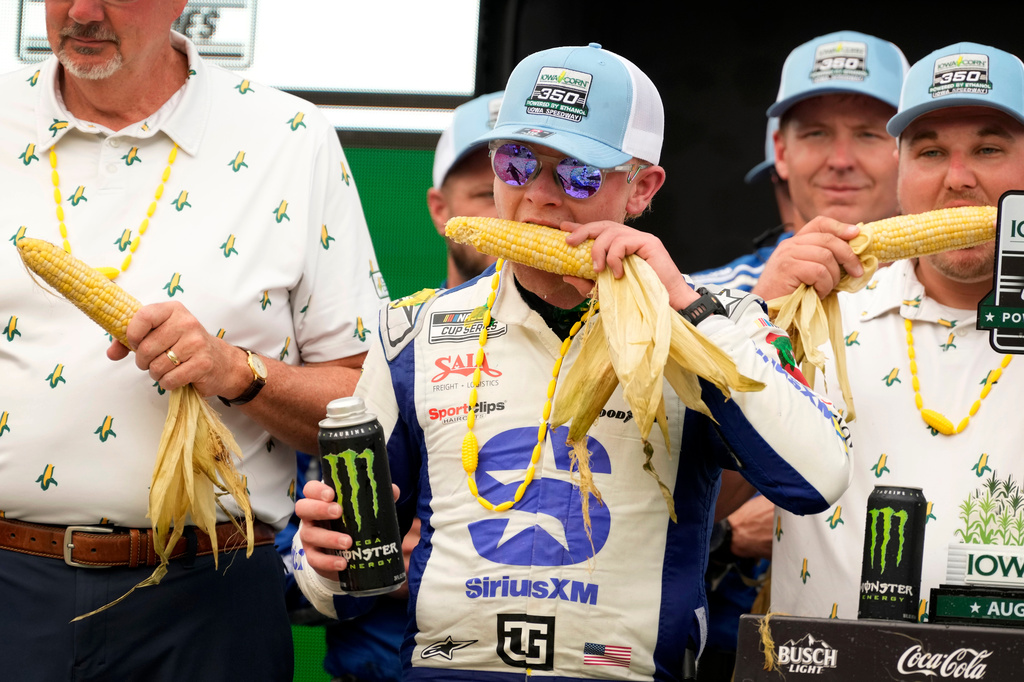 Ty Gibbs eats corn after winning a NASCAR Cup Series auto race, Sunday, Aug. 9, 2026, at Iowa Speedway in Newton, Iowa. (AP Photo/Charlie Neibergall)