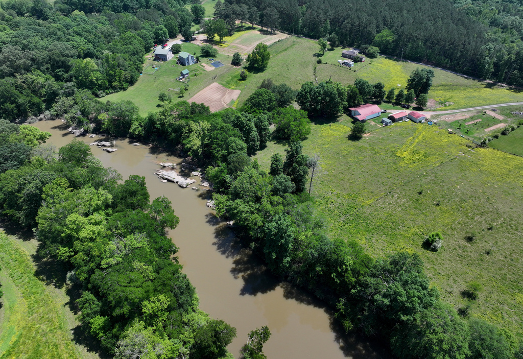 Faye Jackson has lived for decades on a patch of rural land, right, in Resaca, Ga., on the banks of the Conasauga River, seen on Thursday, May 8, 2025. (Hyosub Shin/Atlanta Journal-Constitution via AP)