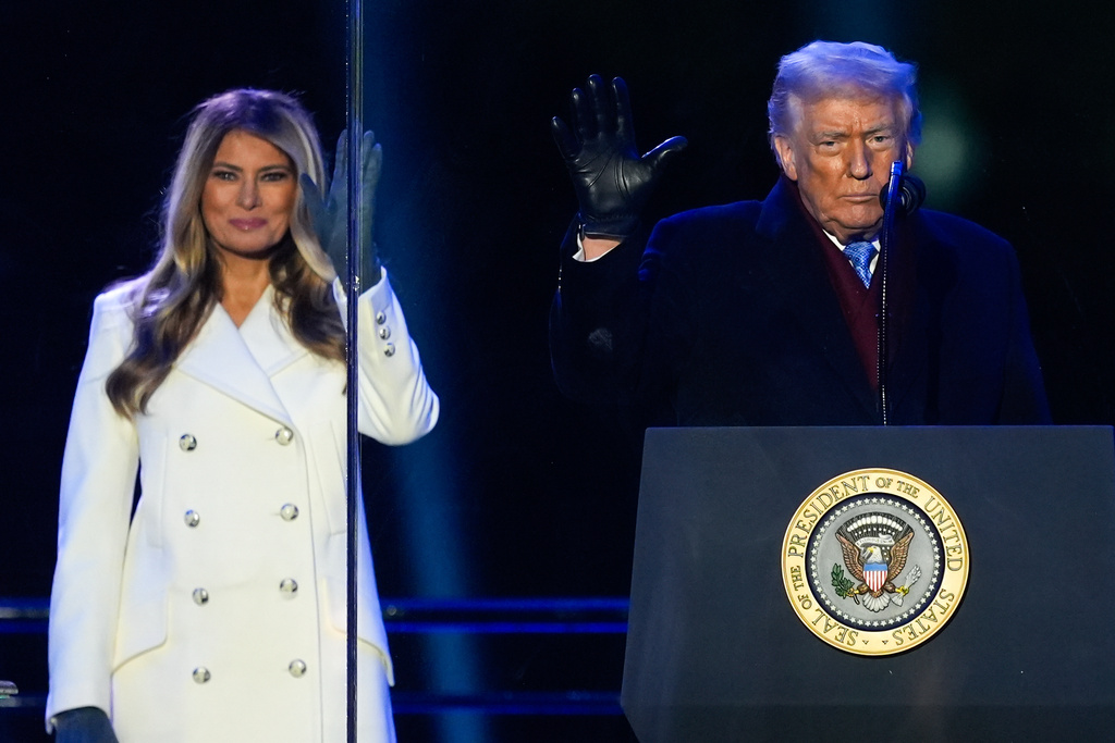 President Donald Trump and first lady Melania Trump wave following the lighting of the National Christmas Tree on the Ellipse, Thursday, Dec. 4, 2025, near the White House in Washington. (AP Photo/Julia Demaree Nikhinson)
