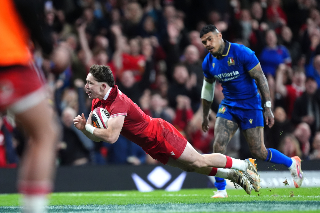 Wales' Daniel Edwards scores their side's fourth try of the game during the Men's Six Nations match between Wales and Italy in Cardiff, Wales, Saturday March 14, 2026. (Mike Egerton/PA via AP)