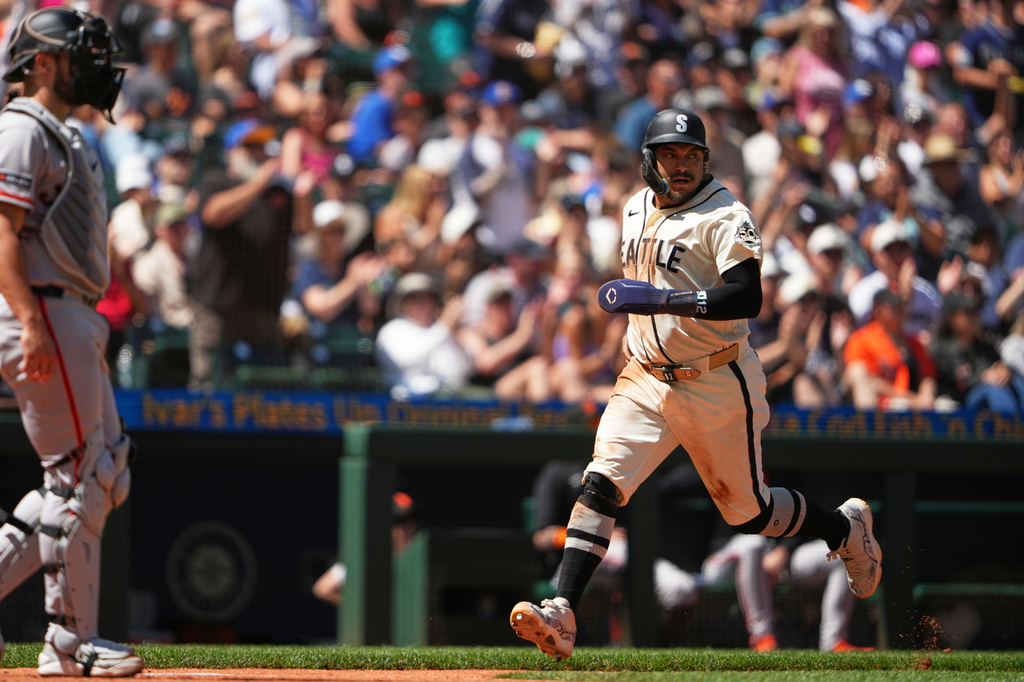 Seattle Mariners' Josh Naylor runs home to score on an RBI single from Weston Wilson during the fourth inning of a baseball game against the San Francisco Giants, Sunday, July 19, 2026, in Seattle. (AP Photo/Lindsey Wasson)