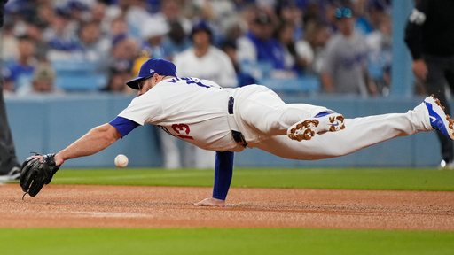 Los Angeles Dodgers third basemam Max Muncy dives but cannot catch a ground ball from Cincinnati Reds' Matt McLain during the third inning in Game 1 of the National League Wild Card baseball playoff series, Tuesday, Sept. 30, 2025, in Los Angeles. (AP Photo/Mark J. Terrill) Los Angeles Dodgers third basemam Max Muncy dives but cannot catch a ground ball from Cincinnati Reds' Matt McLain during the third inning in Game 1 of the National League Wild Card baseball playoff series, Tuesday, Sept. 30, 2025, in Los Angeles. (AP Photo/Mark J. Terrill)