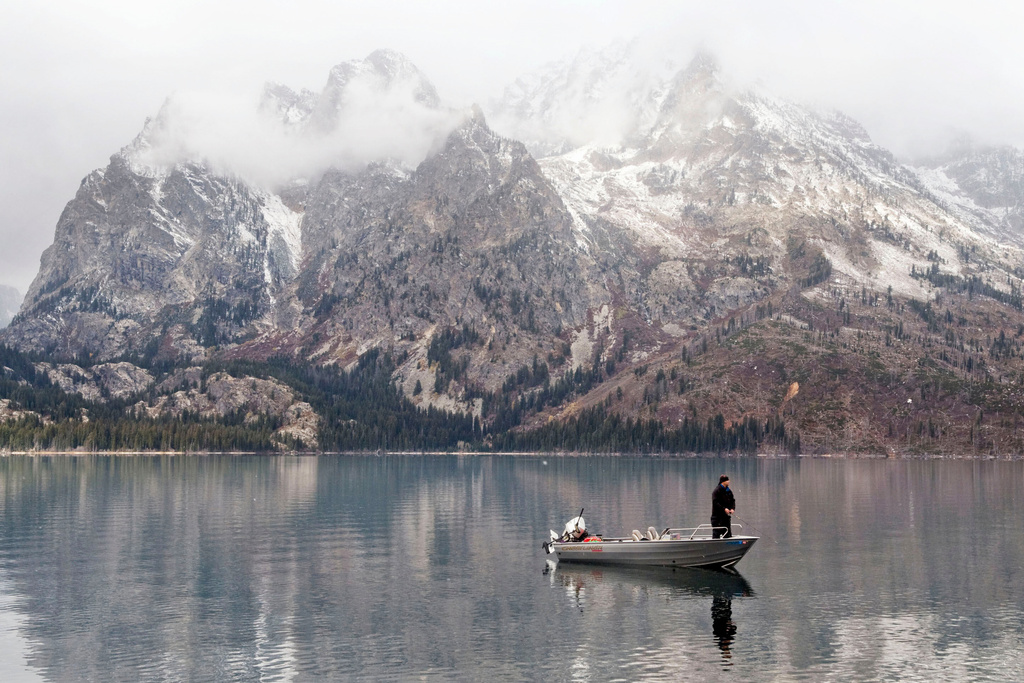 FILE - An angler fishes on Jenny Lake in Grand Teton National Park on Oct. 17, 2013. (Bradly J. Boner/Jackson Hole News & Guide via AP)