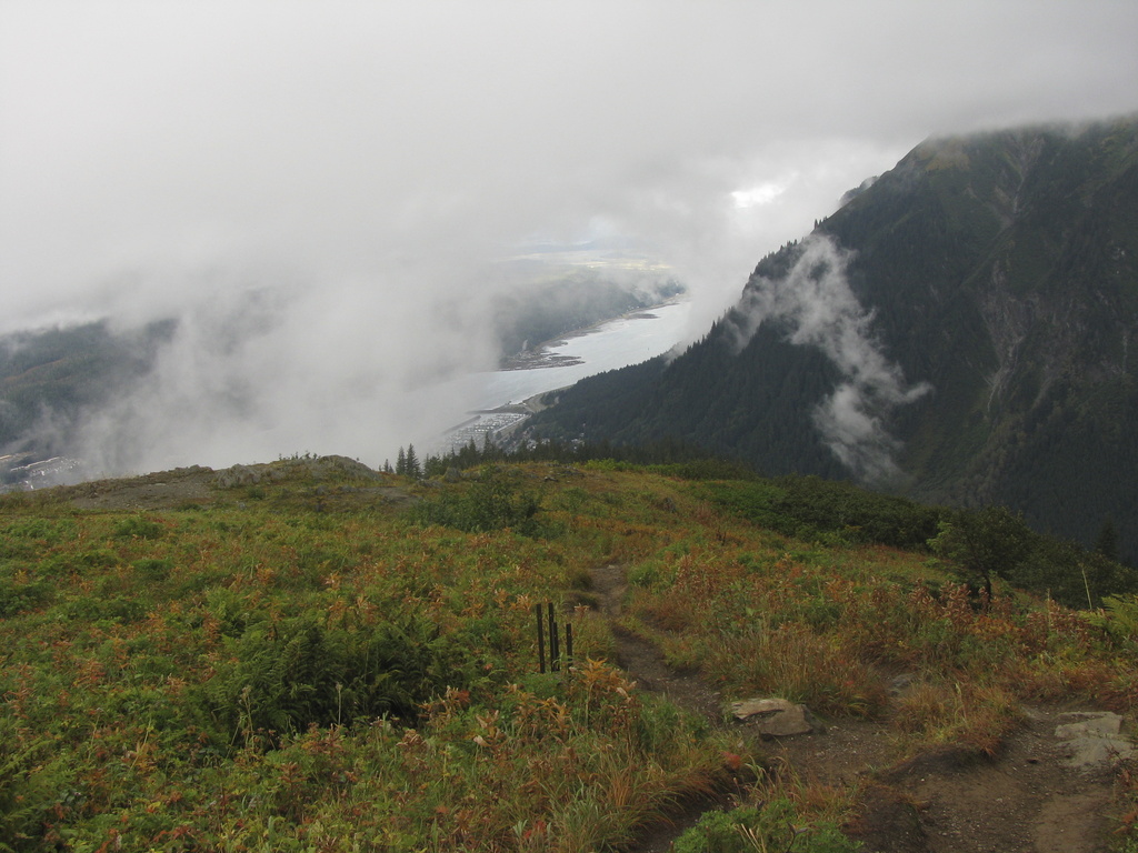 FILE - Clouds and fog hang in the area near and along Mount Roberts trail on Sept. 22, 2012, in Juneau, Alaska. (AP Photo/Becky Bohrer, File)