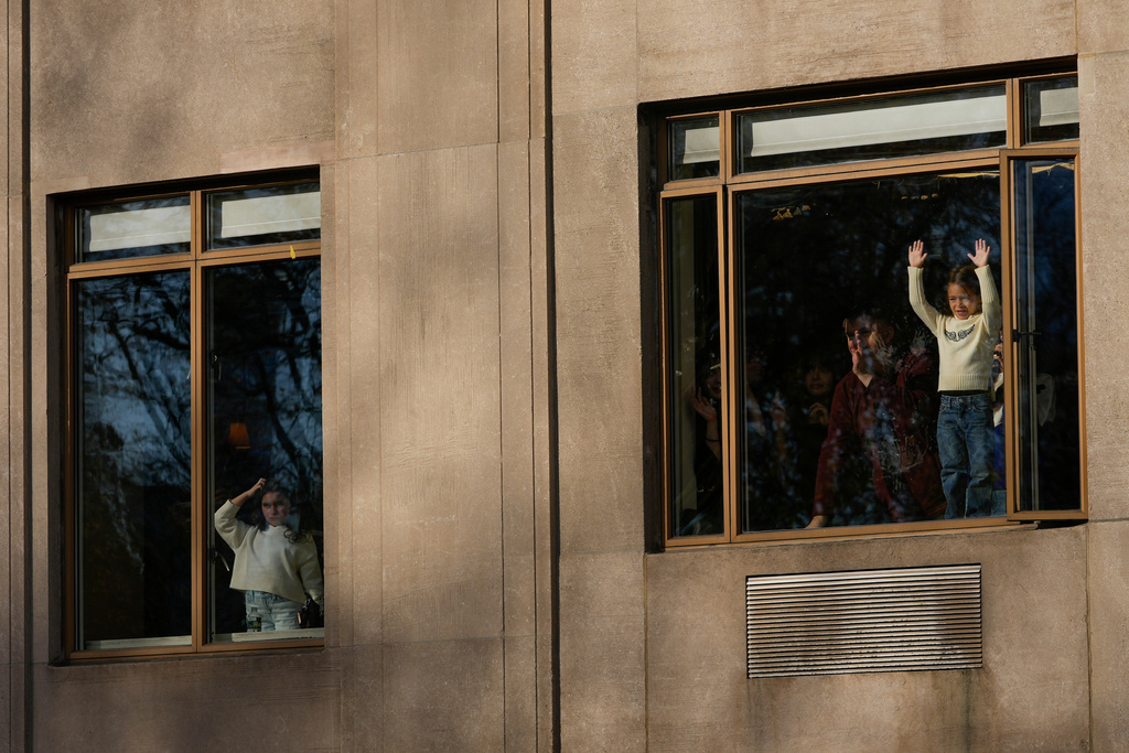 Spectators watch from their apartment windows as the Macy's Thanksgiving Day Parade passes by on Central Park West, Thursday, Nov. 27, 2025, in New York. (AP Photo/Frank Franklin)