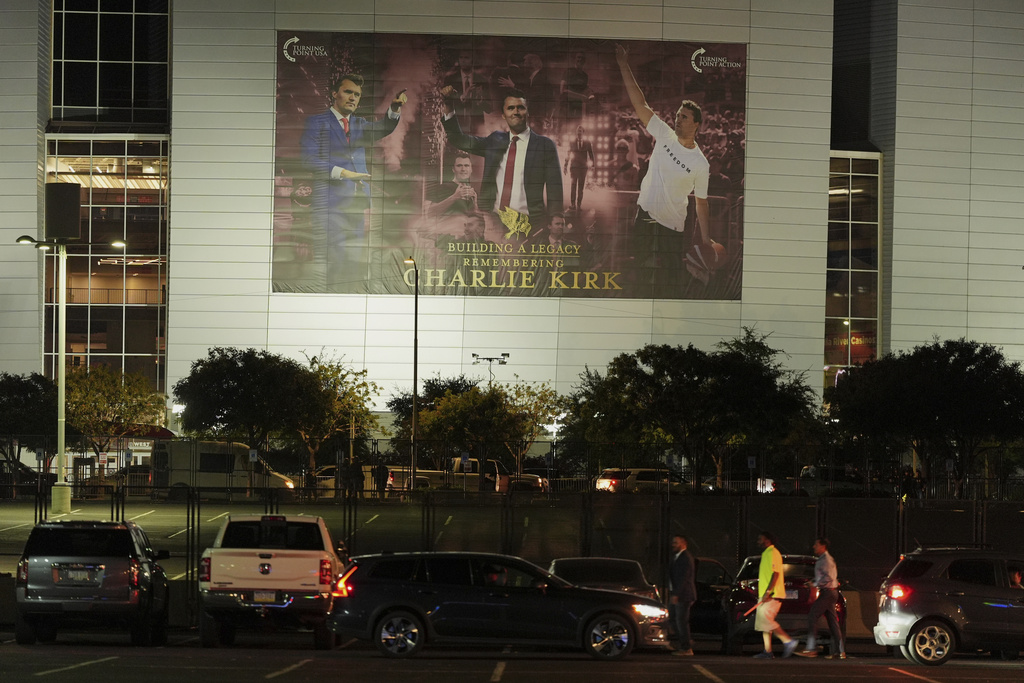 People arrive early for a memorial for conservative activist Charlie Kirk Sunday, Sept. 21, 2025, at State Farm Stadium in Glendale, Ariz. (AP Photo/Jae C. Hong)