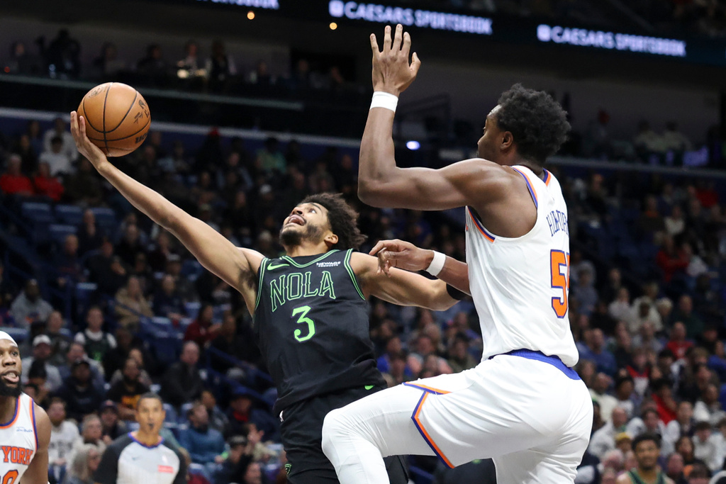New Orleans Pelicans guard Jordan Poole (3) attempts a layup against New York Knicks forward Mohamed Diawara, right, in the first half of an NBA basketball game in New Orleans, Monday, Dec. 29, 2025. (AP Photo/Peter Forest)