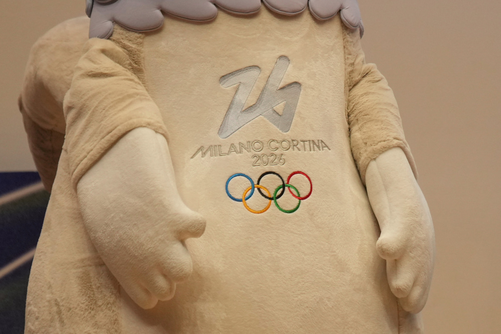 2026 Milan Cortina Winter Olympic podiums are unveiled in Milan, Italy, Wednesday, Oct. 29, 2025, with the mascots Tina and Milo during a press conference marking 100 days to go until the 2026 Milan Cortina Winter Olympics. (AP Photo/Antonio Calanni)