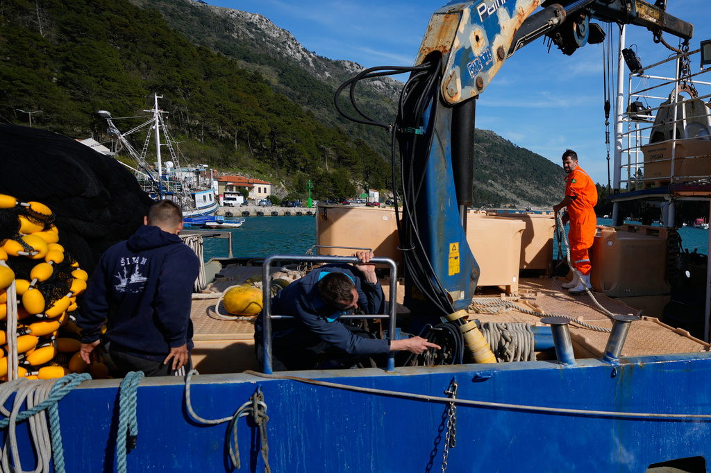 Fishermen prepare to depart for fishing in the port of Plomin, Croatia, Monday, April 6, 2026. (AP Photo/Darko Bandic)