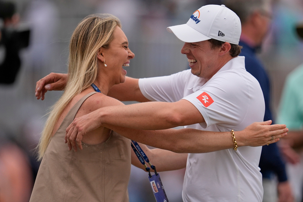 Matt Fitzpatrick, of England, right, hugs his wife Katherine Gaal after winning the RBC Heritage golf tournament Sunday, April 19, 2026, in Hilton Head, S.C. (AP Photo/Mike Stewart)