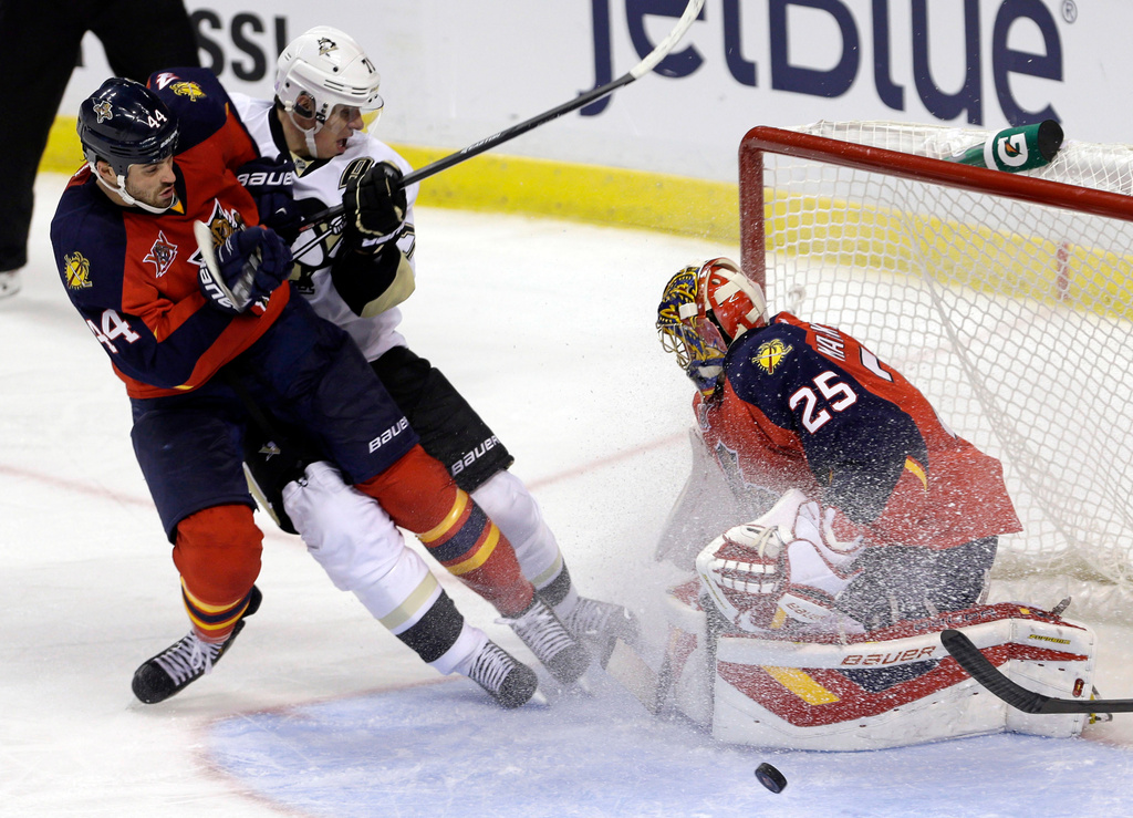 FILE - Florida Panthers goalie Jacob Markstrom (25) blocks a shot by Pittsburgh Penguins' Evgeni Malkin (71) as Panthers' Erik Gudbranson (44) defends in the third period of an NHL hockey game, Oct. 11, 2013, in Sunrise, Fla. (AP Photo/Alan Diaz, File)