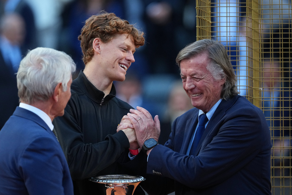 Jannik Sinner, of Italy, is congratulated by former tennis champion Adriano Panatta, right, after defeating Casper Ruud, of Norway, in the final match to win the Italian Open tennis tournament, in Rome, Sunday, May 17, 2026. (AP Photo/Andrew Medichini)