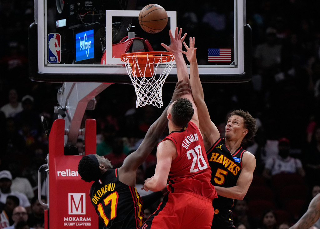 Atlanta Hawks forward Onyeka Okongwu (17) fouls Houston Rockets center Alperen Sengun (28) during the first half of an NBA basketball game in Houston, Friday, March 20, 2026. (AP Photo/Ashley Landis)