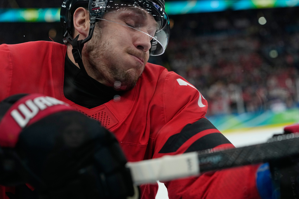 Canada's Bo Horvat (14) crashes into the boards during a men's ice hockey gold medal game between Canada and the United States at the 2026 Winter Olympics, in Milan, Italy, Sunday, Feb. 22, 2026. (AP Photo/Petr David Josek)