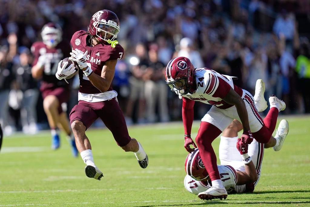 Texas A&M wide receiver Ashton Bethel-Roman (3) looks back at South Carolina defensive back Jalon Kilgore (24) after catching a pass for a first down during the second half of an NCAA college football game Saturday, Nov. 15, 2025, in College Station, Texas. (AP Photo/David J. Phillip)
