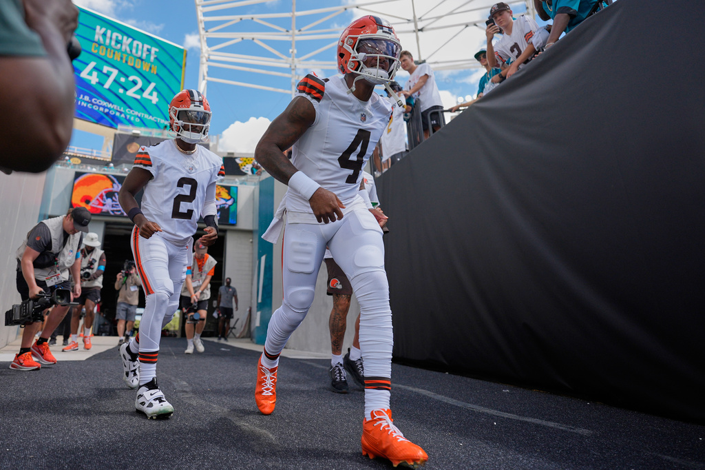 Cleveland Browns quarterback Deshaun Watson (4) and quarterback Shedeur Sanders (2) run onto the field before an NFL football game against the Jacksonville Jaguars, Sunday, Sept. 13, 2026, in Jacksonville. (AP Photo/Mike Stewart)
