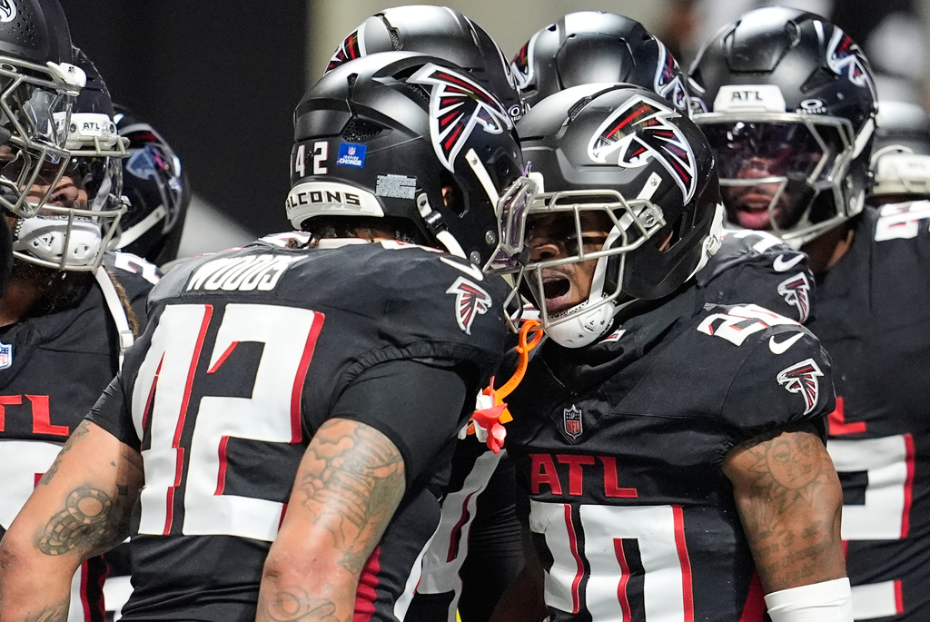 Atlanta Falcons cornerback Dee Alford (20) celebrates his interception with linebacker Josh Woods (42) in the second half of an NFL football game against the New Orleans Saints, Sunday, Jan. 4, 2026, in Atlanta. (AP Photo/Mike Stewart)