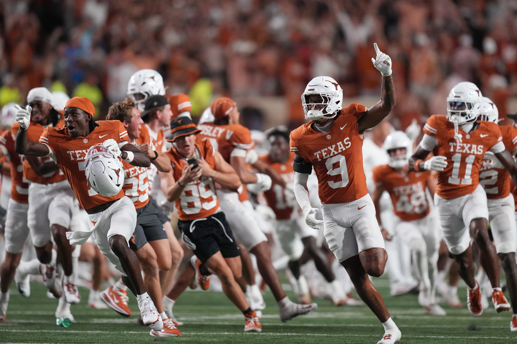 Texas players celebrate their win over Ohio State in an NCAA college football game in Austin, Texas, Saturday, Sept. 12, 2026. (AP Photo/Eric Gay)