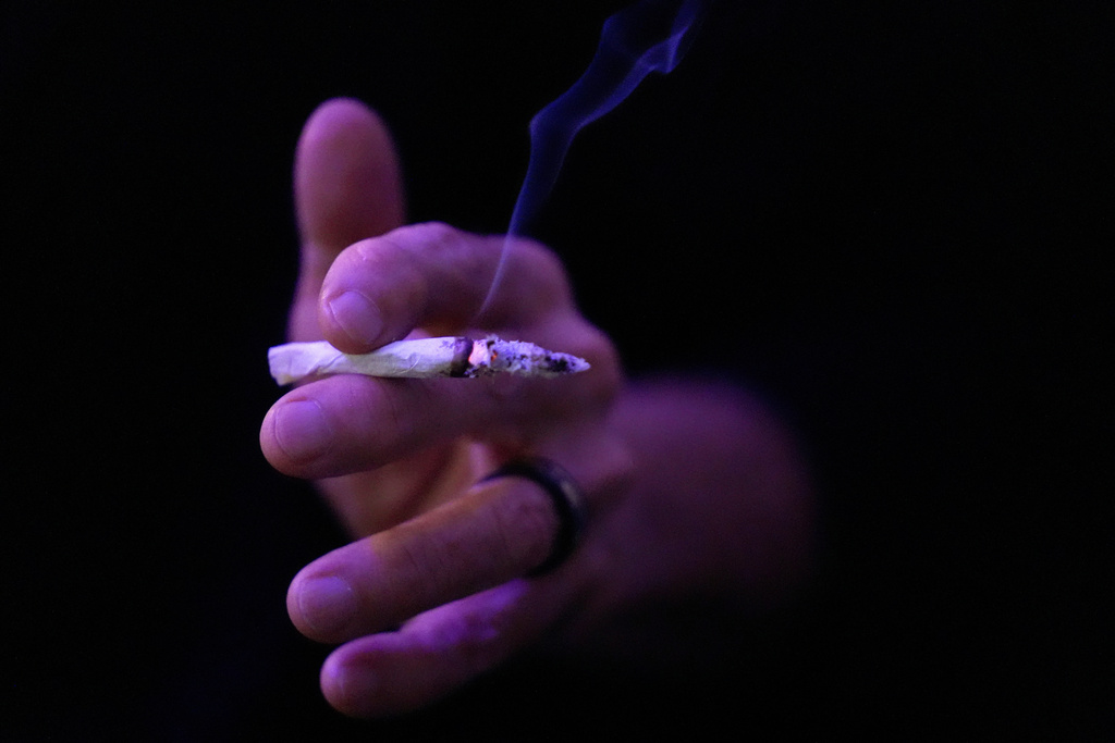 Miguel Laboy smokes a joint on Oct. 3, 2025, in Brookline, Mass. (AP Photo/Robert F. Bukaty)