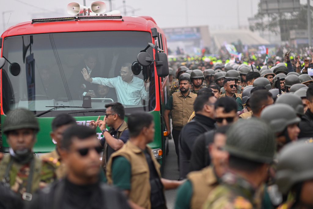 Bangladesh Nationalist Party (BNP) Acting Chairman Tarique Rahman waves to supporters from a bus in Dhaka after returning from London, ending more than 17 years of self-imposed exile, Thursday, Dec. 25, 2025.(AP Photo/Mahmud Hossain Opu)
