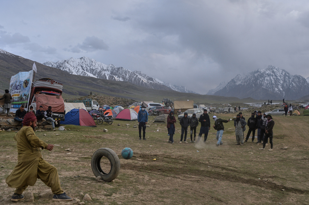 Spectators play a game at a temporary tent settlement during the three-day annual Shandur Polo Festival in Shandur Pass in the Ghizer district of Gilgit-Baltistan, northern Pakistan, Friday, June 12, 2026. (AP Photo/Zubair Abbasi)
