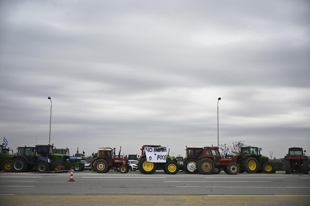 Tractors block a highway as farmers and supporters protest delays in farm subsidy payments at the Malgara toll stations near Thessaloniki, northern Greece, Wednesday, Dec. 3, 2025. (AP Photo/Giannis Papanikos)