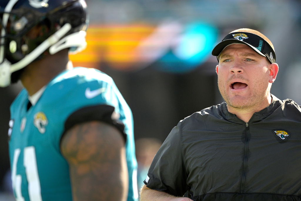 FILE -Jacksonville Jaguars defensive line coach Tosh Lupoi, right, calls out instructions on the sideline during the second half of an NFL football game against the Indianapolis Colts, Jan. 9, 2022, in Jacksonville, Fla. (AP Photo/Phelan M. Ebenhack, File)