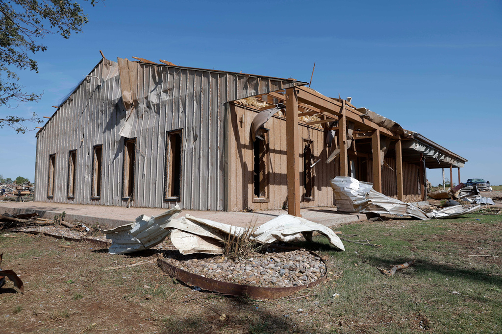 A commercial business shop in a neighborhood that was damaged by a tornado on Thursday is shown on Friday, April 24, 2026, in Enid, Okla. (AP Photo/Alonzo Adams)