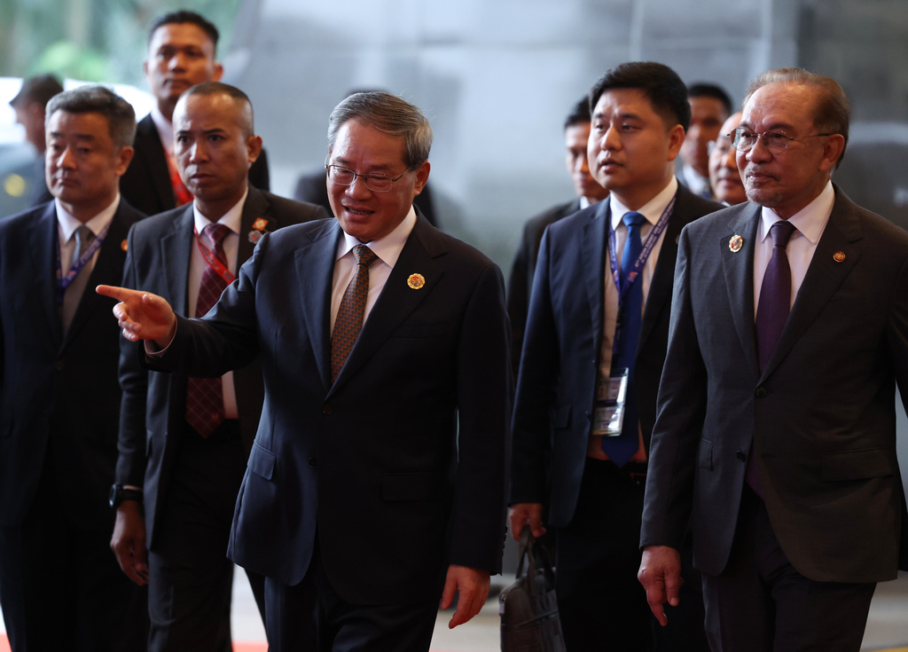 Malaysian Prime Minister Anwar Ibrahim, front right, and Chinese Premier Li Qiang, front left, arrive ahead of the signing ceremony for the ASEAN–China Free Trade Area 3.0 Upgrade and the ASEAN–China summit, held as part of the ASEAN summit in Kuala Lumpur, Malaysia Tuesday, Oct. 28, 2025. (Chalinee Thirasupa/Pool Photo via AP)