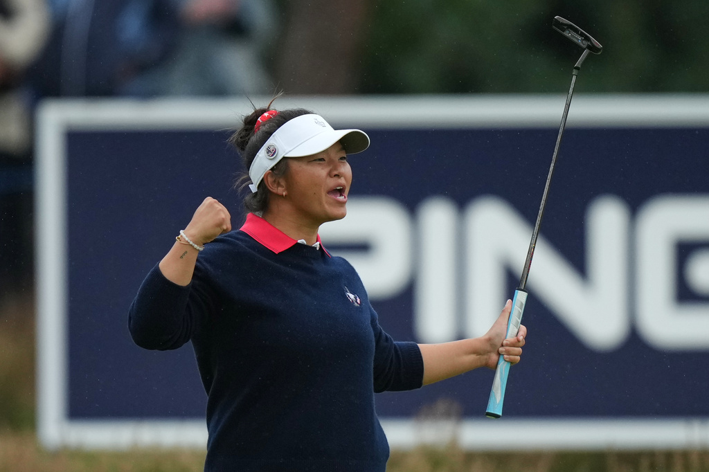 Megan Khang of the United States reacts after sinking a putt on the 12th green during the Solheim Cup in Den Bosch, Netherlands, Friday, Sept. 11, 2026. (AP Photo/Alastair Grant)