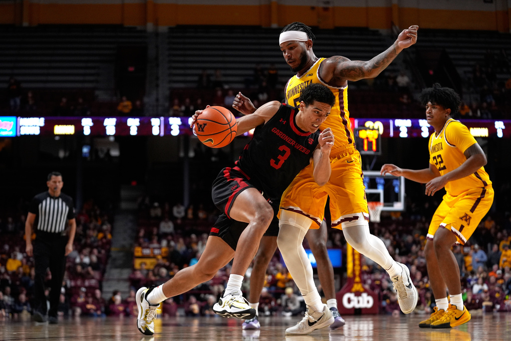 Gardner-Webb guard Julius Clark (3) works toward the basket as Minnesota forward Jaylen Crocker-Johnson, back, defends during the second half of an NCAA college basketball game Monday, Nov. 3, 2025, in Minneapolis. (AP Photo/Abbie Parr)