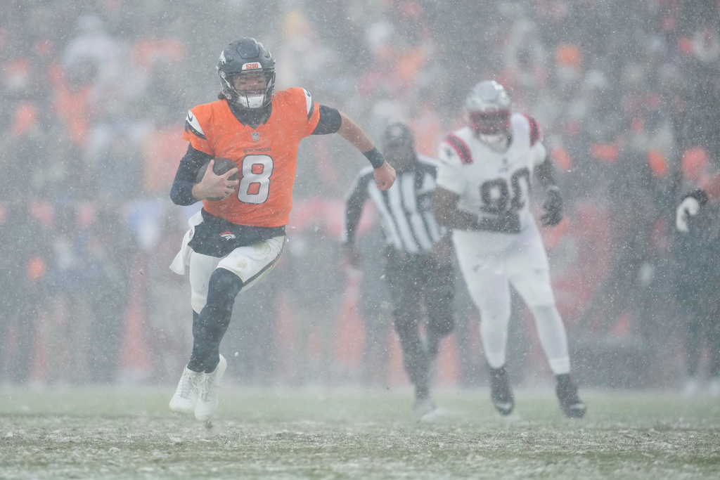 Denver Broncos quarterback Jarrett Stidham (8) runs against the New England Patriots during the second half of the AFC Championship NFL football game, Sunday, Jan. 25, 2026, in Denver. (AP Photo/Ashley Landis)