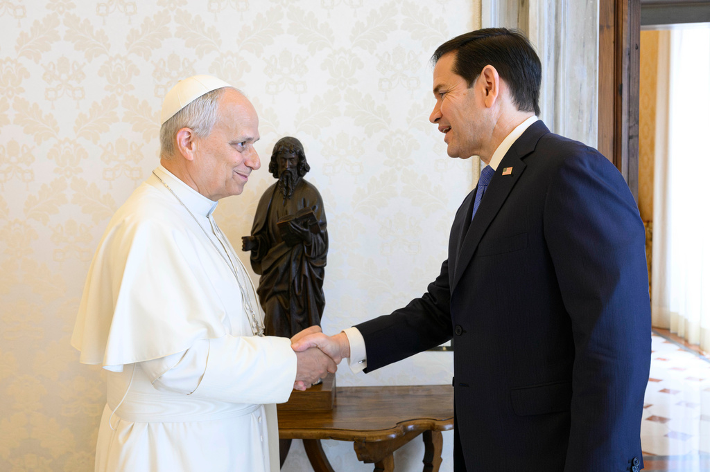 In this handout photo provided by Vatican Media Pope Leo XIV greets U.S. Secretary of State Marco Rubio, right, upon his arrival for talks in the pope's private library at the Vatican, Thursday, May 7, 2026. (Vatican Media via AP)