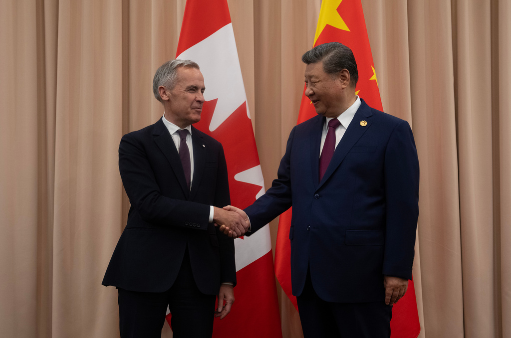 FILE - Canadian Prime Minister Mark Carney, left, shakes hands with Chinese President Xi Jinping at the start of a meeting in Gyeongju, South Korea, Oct. 31, 2025. (Adrian Wyld/The Canadian Press via AP, File)