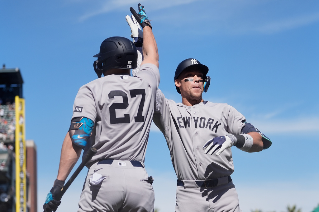 New York Yankees' Aaron Judge, right, is congratulated by Giancarlo Stanton (27) after hitting a two-run home run that also scored Paul Goldschmidt during the sixth inning of a baseball game against the San Francisco Giants in San Francisco, Friday, March 27, 2026. (AP Photo/Jeff Chiu)