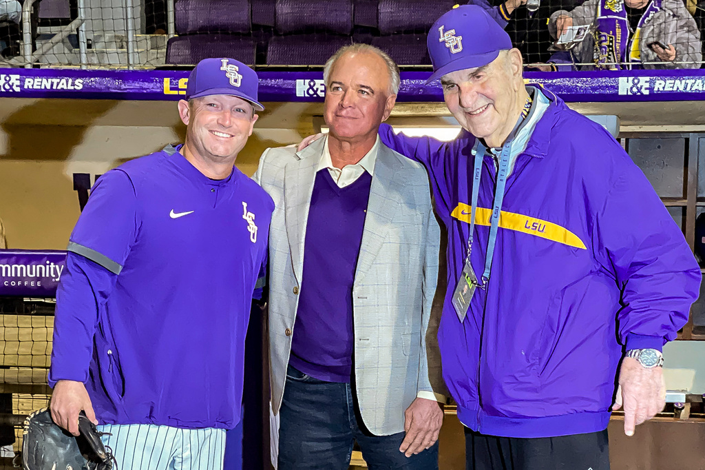 FILE - LSU head coach Jay Johnson, left, smiles with retired head coach Paul Mainieri, and head coach Skip Bertman before an NCAA baseball game against Maine on Feb. 18, 2022, in Baton Rouge, (AP Photo/Matthew Hinton, File)