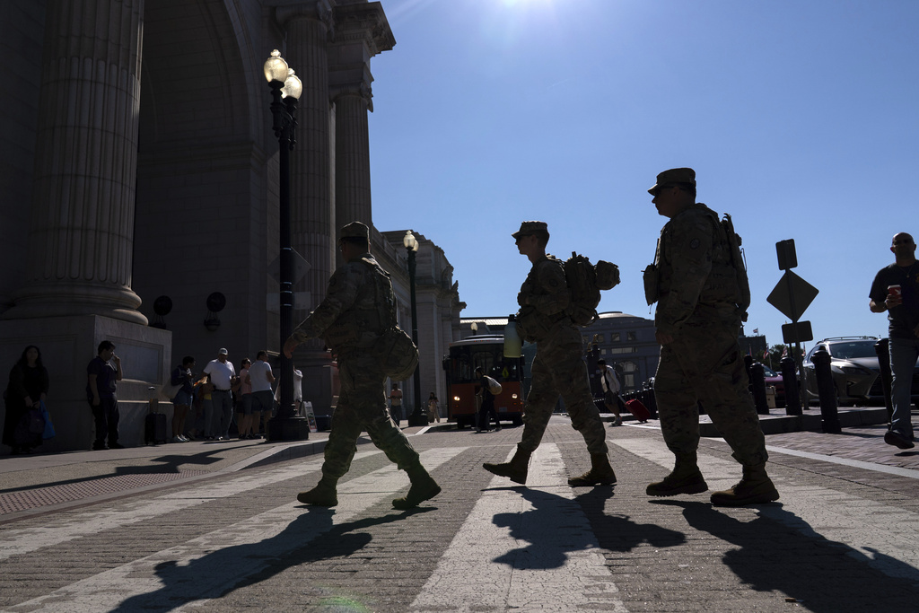 Members of the District of Columbia National Guard patrol the train passenger area in Union Station, Saturday, Aug. 23, 2025, in Washington. (AP Photo/Jose Luis Magana)