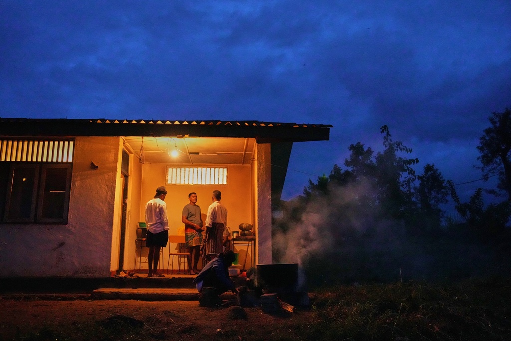 Tea plantation workers and their children who evacuated after Cyclone Ditwah led to floods and landslides take shelter at a safety center at Craighead Estate in Nawalapitiya, Sri Lanka, Thursday, Dec. 11, 2025. (AP Photo/Eranga Jayawardena)