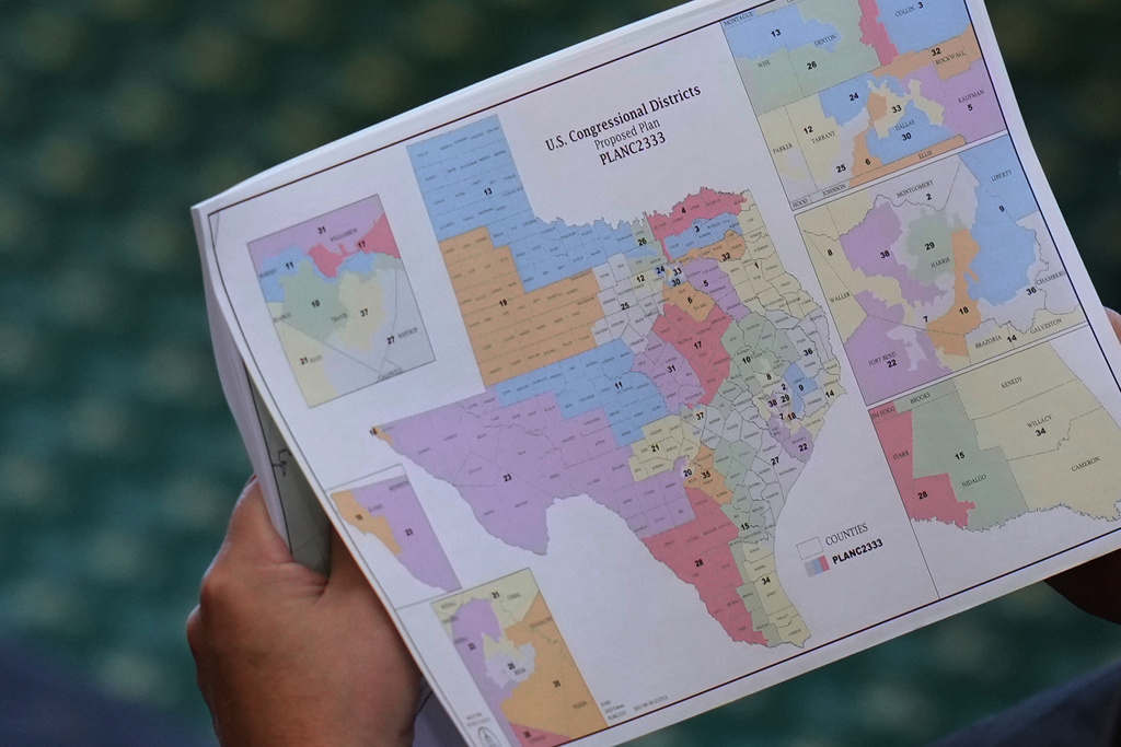 FILE - Texas state Sen. Pete Flores, R-Pleasanton, looks over a redrawn U.S. congressional map during debate over a bill in the Senate Chamber at the Texas Capitol in Austin, Texas, Aug. 22, 2025. (AP Photo/Eric Gay, File)