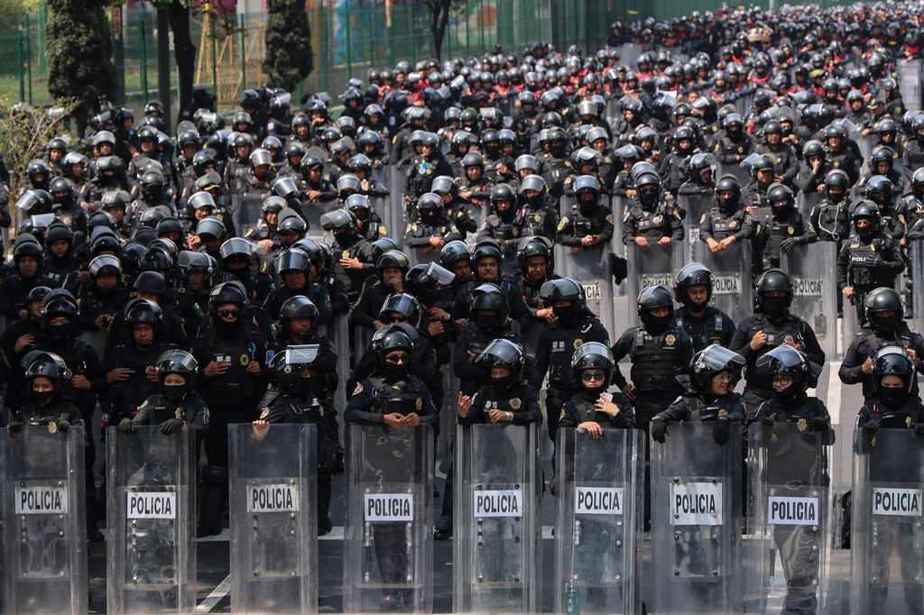 Police officers block a street to the stadium ahead of the opening match of the 2026 FIFA World Cup between Mexico and South Africa in Mexico City, Thursday, June 11, 2026. (AP Photo/Ginnette Riquelme)
