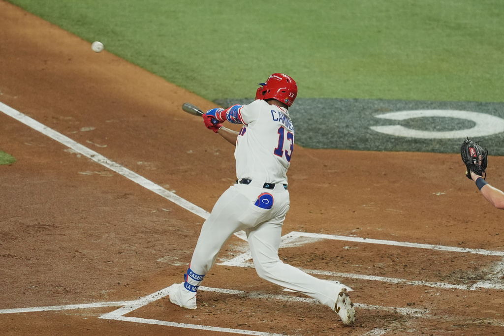 Dominican Republic's Junior Caminero (13) hits a home run during the second inning of a World Baseball Classic semifinal game against the United States, Sunday, March 15, 2026, in Miami. (AP Photo/Rebecca Blackwell)